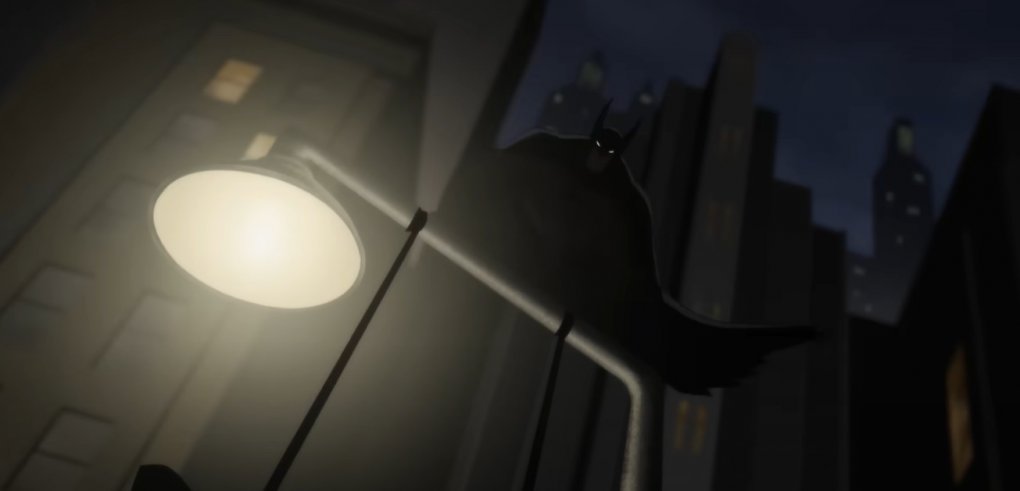Batman hockt auf einer Laterne.