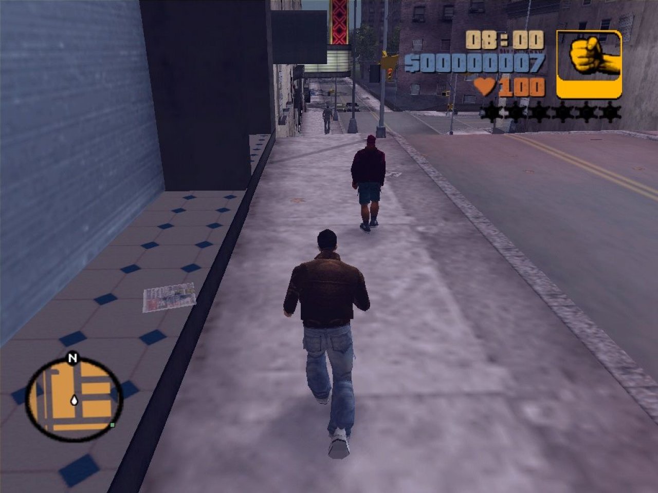 [28/10/2021] Ein typisches Bild aus GTA 3: Die eigene Spielfigur joggt die Straße entlang. Vor ihr sieht man Fußgänger und Geschäfte. Oben rechts durch die Polizei-Sterne dargestellt: das Fahndungslevel. &nbsp;