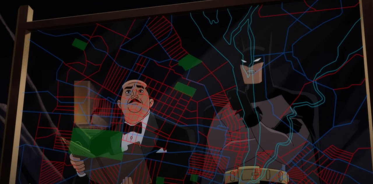 Batman und Alfred vor einer Karte der Stadt in der Bathöhle.
