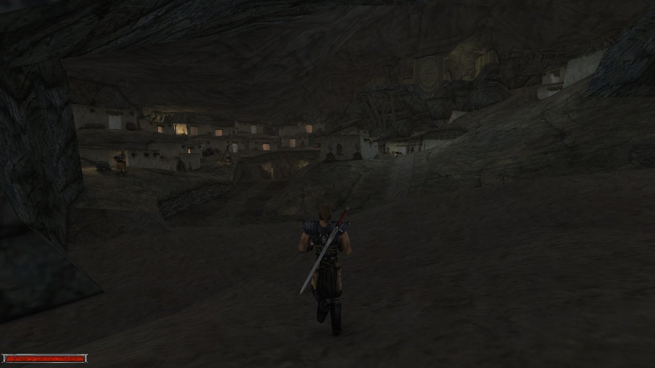 Der Held blickt in eine große Höhle mit vielen Häusern im originalen Gothic.