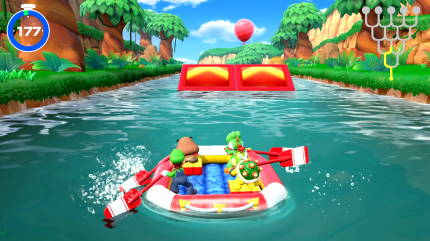 Gumba, Yoshi, Luigi und Bowser Jr. fahren im Modus Raft-Abenteuer von Super Mario Party für Nintendo Switch über den Fluss auf eine Sprungschanze und einen Minispiel-Luftballon zu.