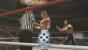 WWE 2K14 im Test für PS3: Spezielle Wrestlemania-Momente werden auch in Quicktime-Events dargestellt. Hier bekommt zum Beispiel der bedauernswerte Referee Bret Harts Clothesline ab - autsch.